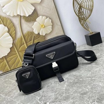 Black nylon camera bag with a wide strap and a small pouch attached