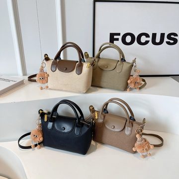 Four mini top-handle bags in beige, khaki, black and brown with plush charms