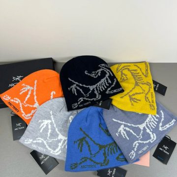 Knit beanies in several colours with a white line pattern