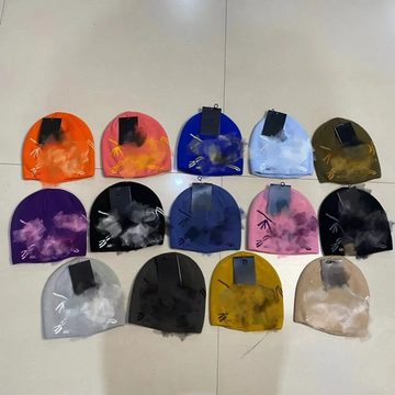 Grid of tie-dye knit beanies in orange, pink, blue, purple and grey