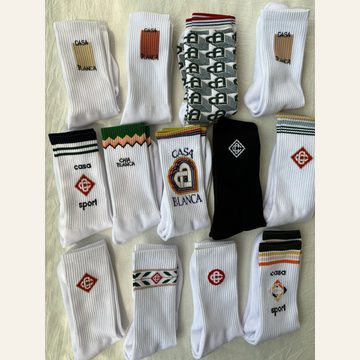 Assorted white and black crew socks with knitted graphics and stripes