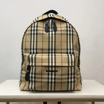 Beige check-pattern backpack with a rounded zip top and a front pocket