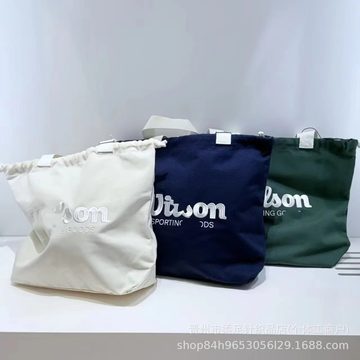 Three canvas drawstring bags in white, navy and green with printed script lettering