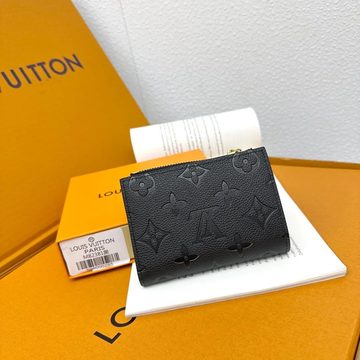 Black zip coin purse with an embossed pattern resting on an orange box