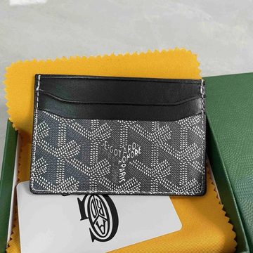 Grey printed canvas card holder with black trim, held above a green box