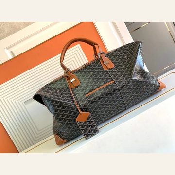Black printed holdall with tan handles on a white table