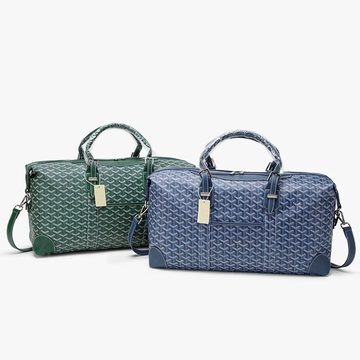 Two printed holdalls, one green and one blue, side by side