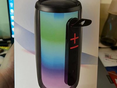 Cylindrical portable speaker with coloured lights inside its retail box